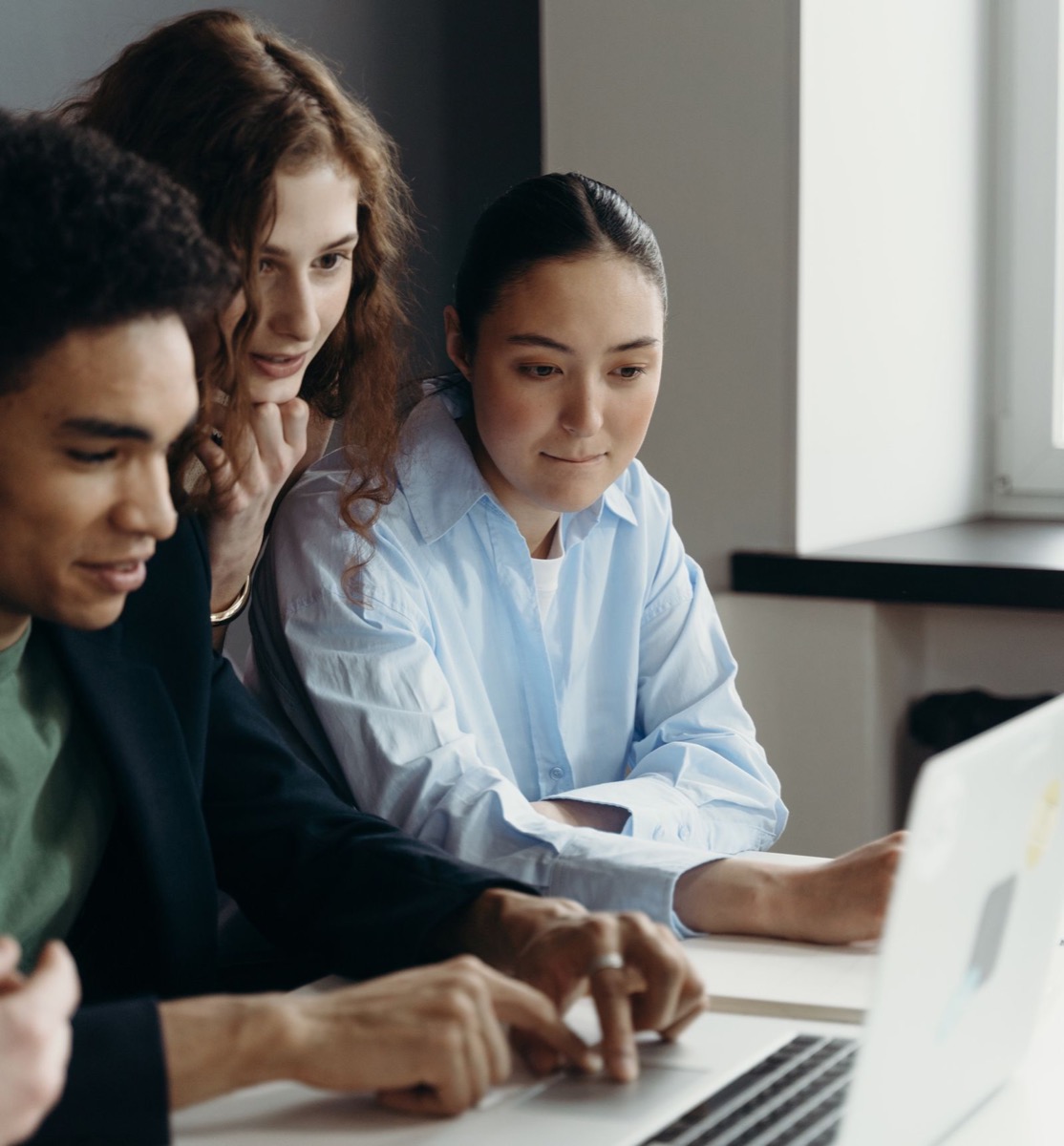 Colleagues looking at a laptop together